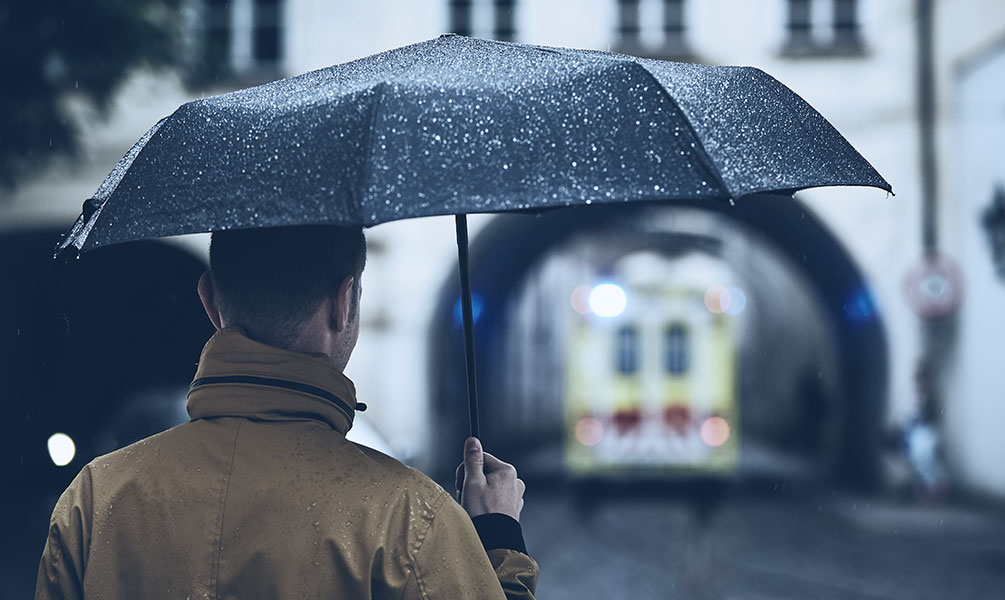 man holding umbrella in the rain